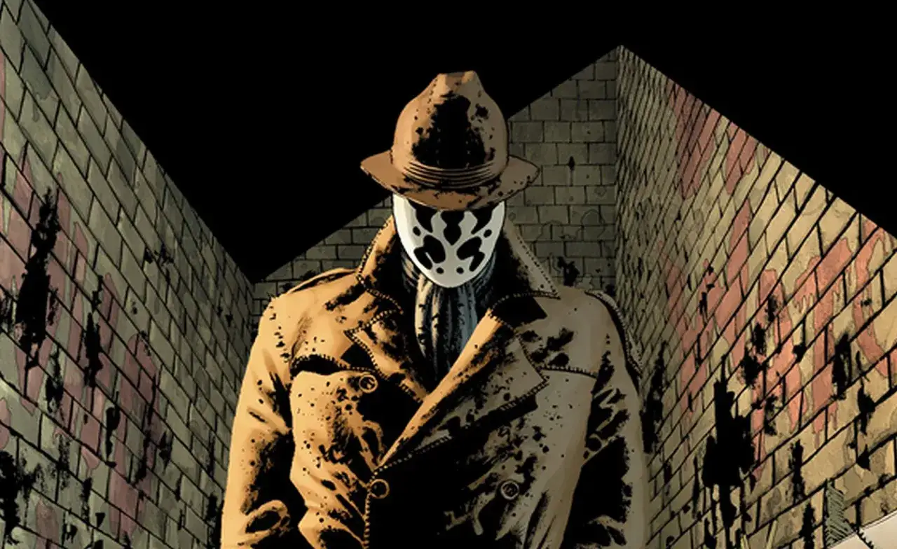 Rorschach w prochowcu i kapeluszu, z maską na twarzy, symbolizuje różnicę między antybohaterem a złoczyńcą na przykładzie literatury współczesnej.